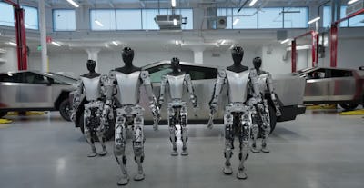 An image of the Tesla Bot prototypes in front of the Cybertruck.