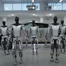 An image of the Tesla Bot prototypes in front of the Cybertruck.