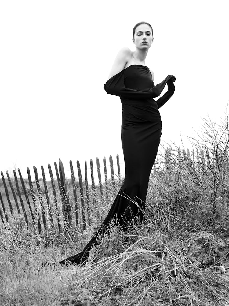Model wears a black dress.