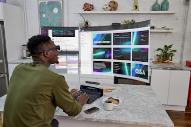 Someone using the Spacetop to interact with multiple virtual displays.