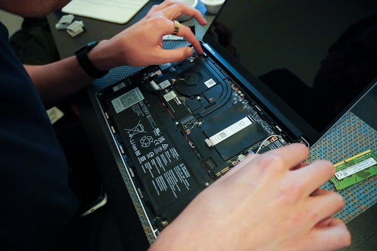 Removing the mainboard from the Framework Laptop.