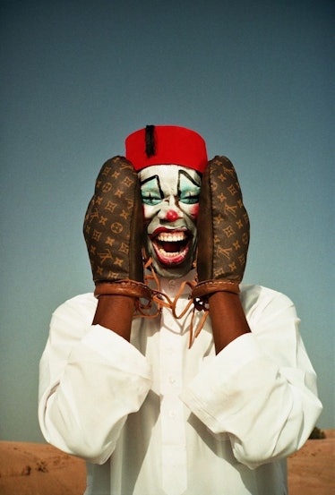 A clown wearing Louis Vuitton boxing gloves
