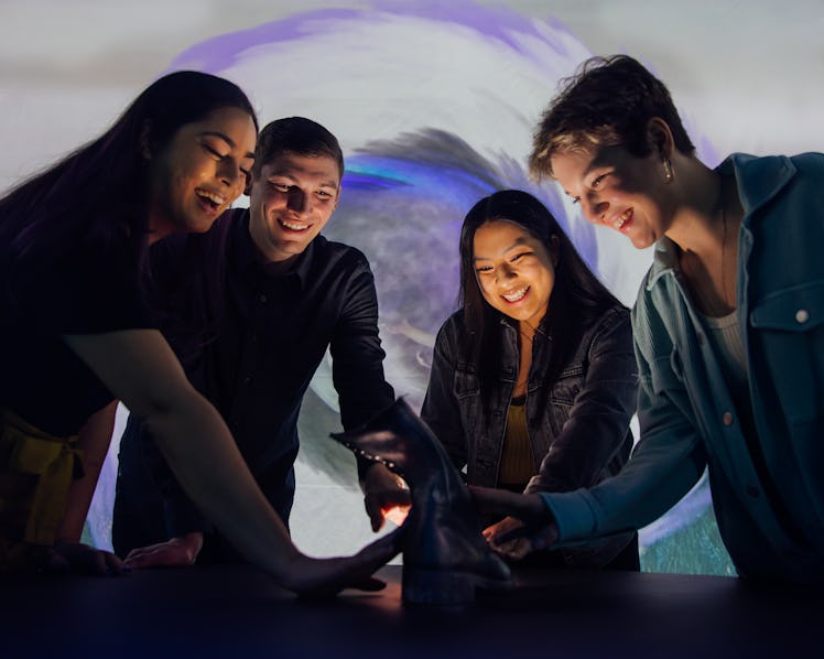 Friends participating in the portkey experience at Harry Potter: The Exhibition in NYC.