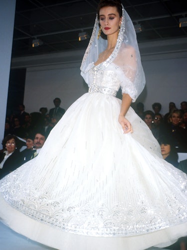 Haute Couture Spring/Summer 1988. Model Ines de la Fressange wearing flowing silver sequined white w...