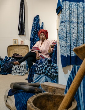Marie-Madeleine Diouf, seated among her indigo pieces. All artists featured throughout wear their ow...