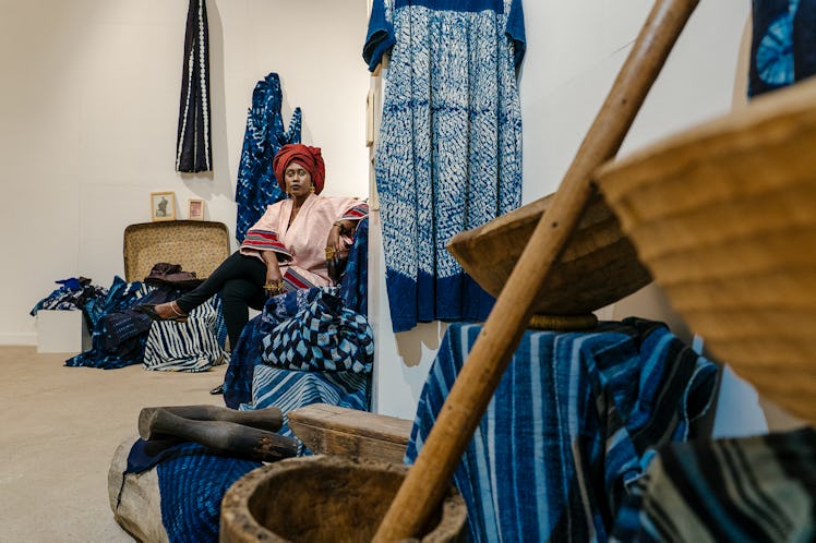 Marie-Madeleine Diouf, seated among her indigo pieces. All artists featured throughout wear their ow...