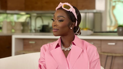 Chelsea Lazkani in a pink top with pink sunglasses atop her head on Selling Sunset Season 6. 