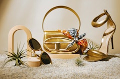 gold diesel 1DR bag, gold sandals, and gold sunglasses for summer 2023