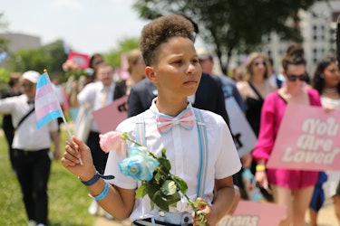 A child waves a transgender flag at Trans Prom