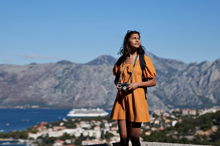 Young woman on top of a mountain during the June 2023 full Strawberry Moon, which will affect every ...
