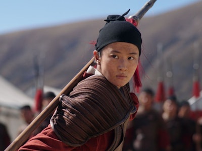 Yifei Liu carries a staff on her back in 2020's Mulan