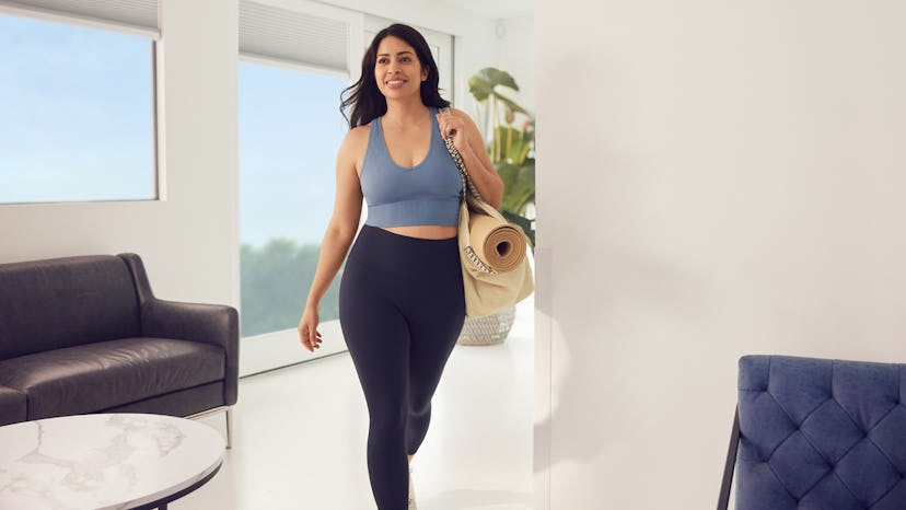 woman smiling walking through her living room