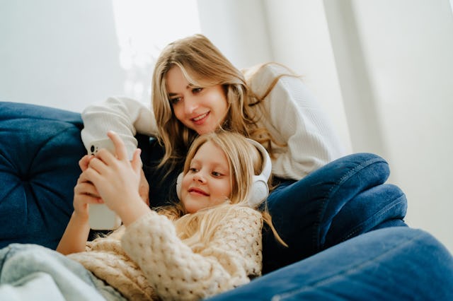 Mother and daughter listen to music together.