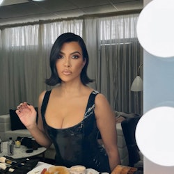 Kourtney Kardashian black nails sitting at makeup table