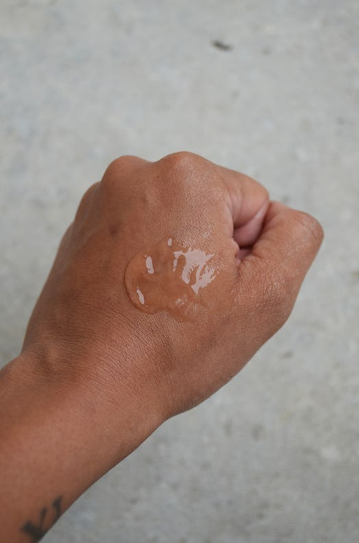 A photo of a hand with hair gel on the back of it.