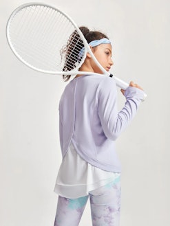model rocking moody tiger cute activewear clothes for kids, holding a tennis racket