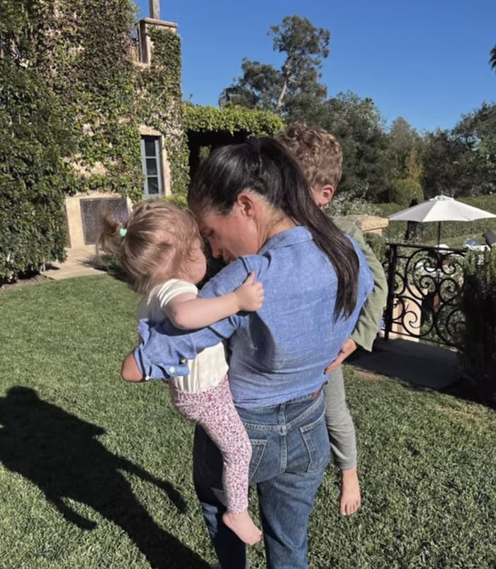Meghan Markle holding her children, Archie and Lilibet, in a photo from 'Harry & Meghan.'