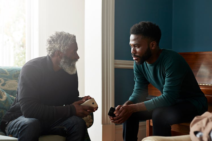 Young man listening intently to older man