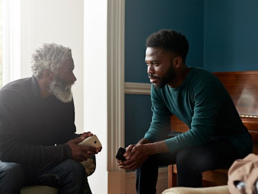 Young man listening intently to older man