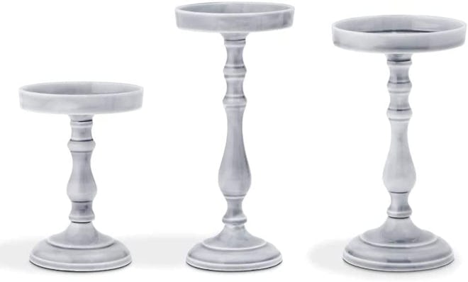 Use these decorative candle holders to elevate pillar candles for centerpieces or on top of your man...