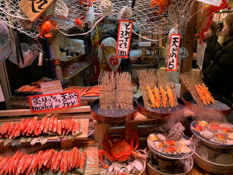 Visiting Nishiki food market in Kyoto, Japan which has a lot of seafood and meat skewers for cheap p...