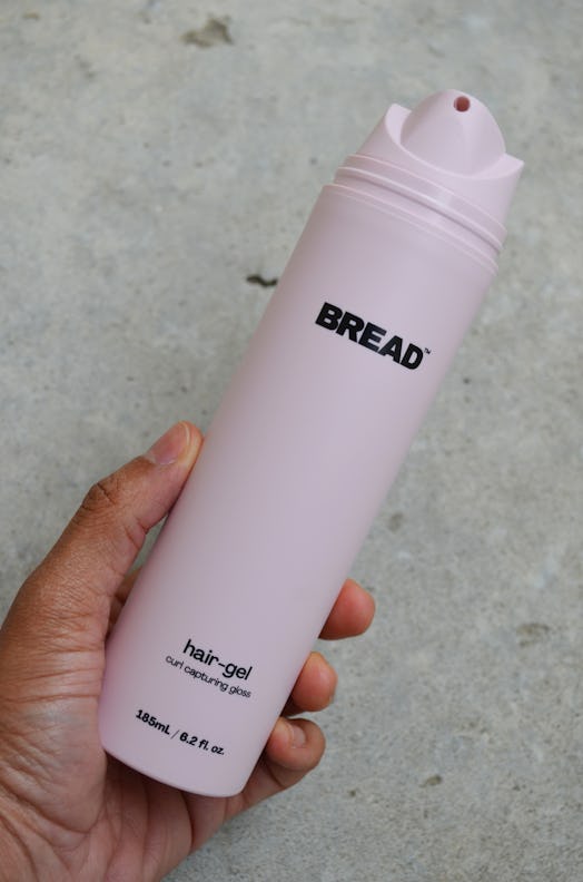 A picture of a hand holding the Bread Beauty Supply Hair-Gel. 