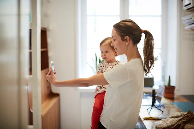 A woman takes a selfie with her child.