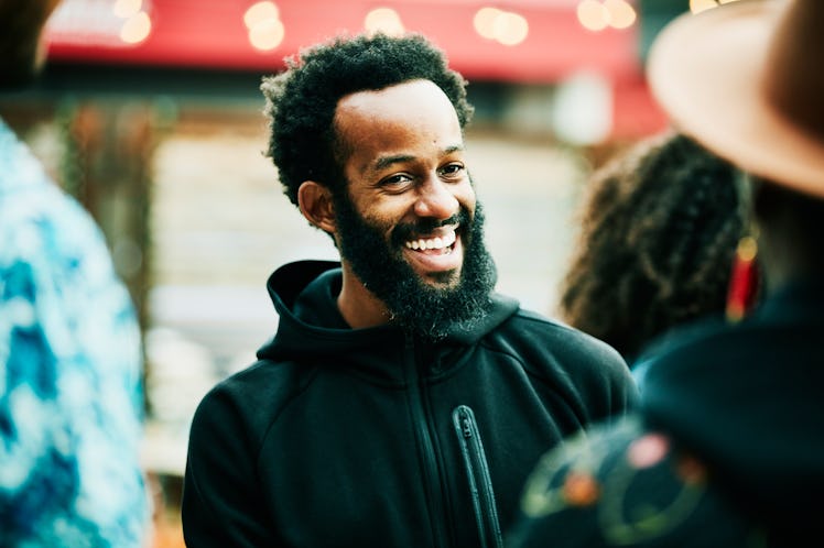 Smiling man having a conversation with a friend