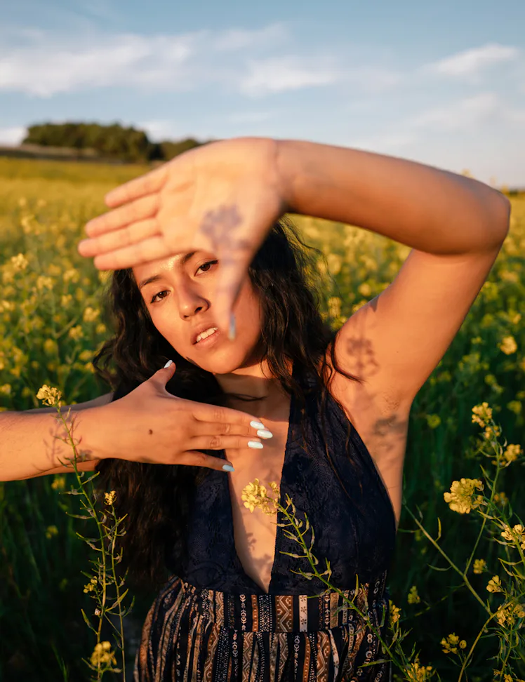 Young woman in a field, having the best spring, which she manifested.