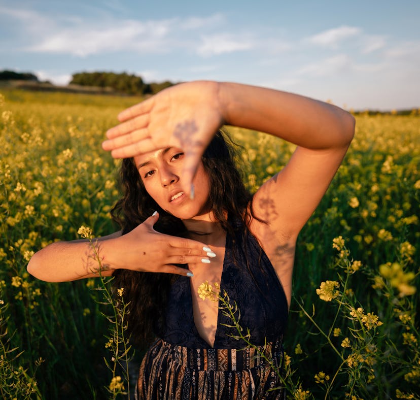 Young woman in a field, having the best spring, which she manifested.