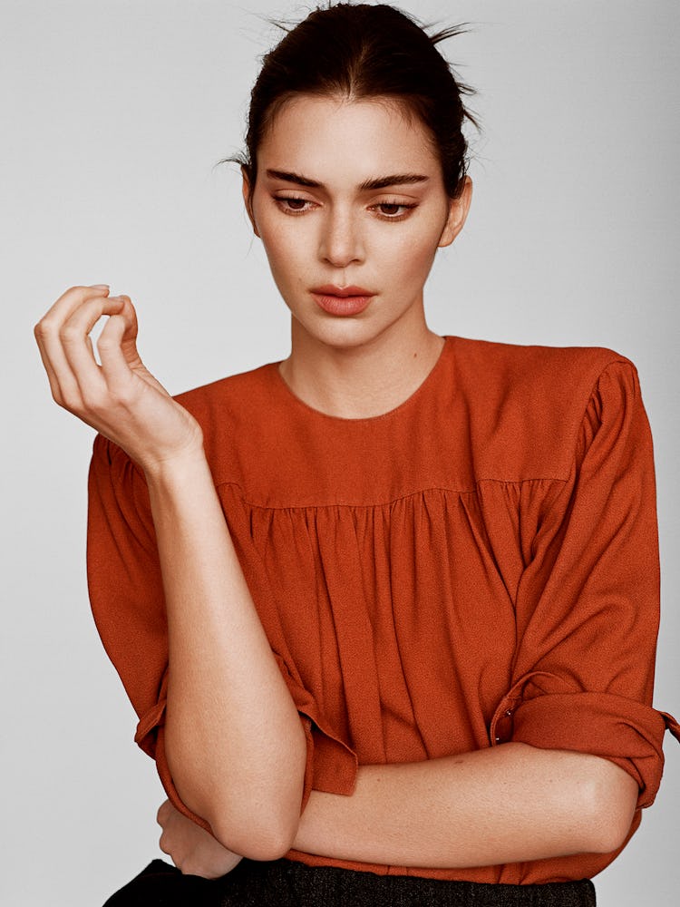 Model Kendall Jenner wears a maroon blouse.