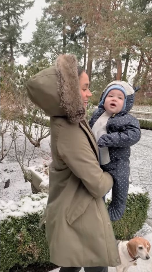Meghan Markle holds Archie, who is experiencing snow for the first time.