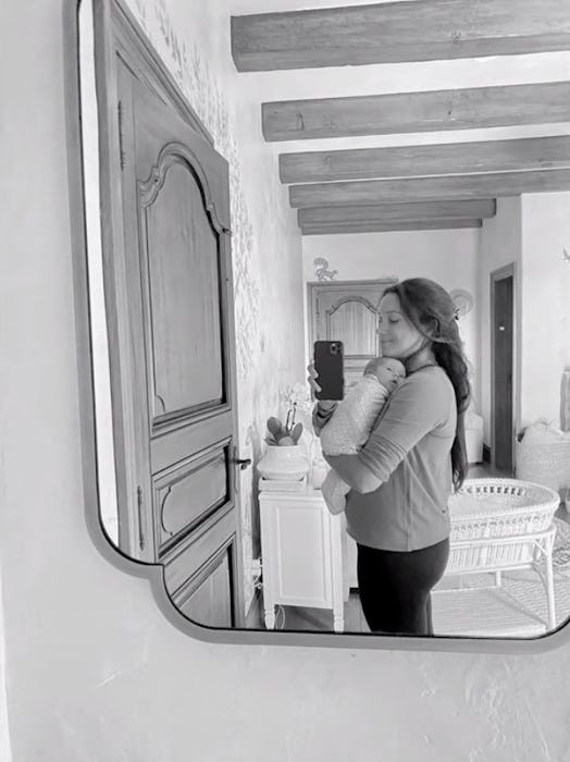 A mirror selfie of Meghan Markle holding baby Lilibet