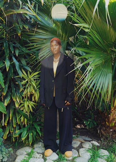 Arlo Parks wears an MM6 Maison Margiela jacket and sweatpants; Jacquemus top and shoes; Tiffany & Co...