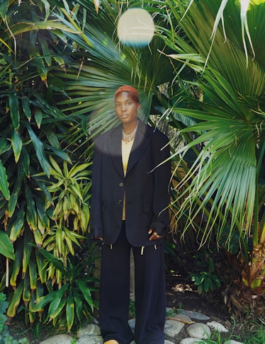 Arlo Parks wears an MM6 Maison Margiela jacket and sweatpants; Jacquemus top and shoes; Tiffany & Co...