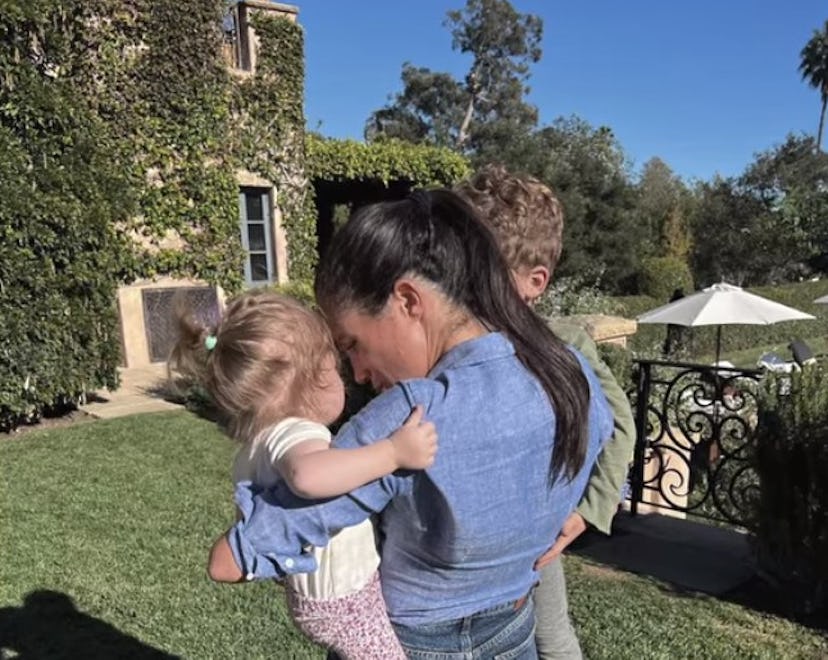 Meghan Markle holds Archie and Lilibet in her arms.