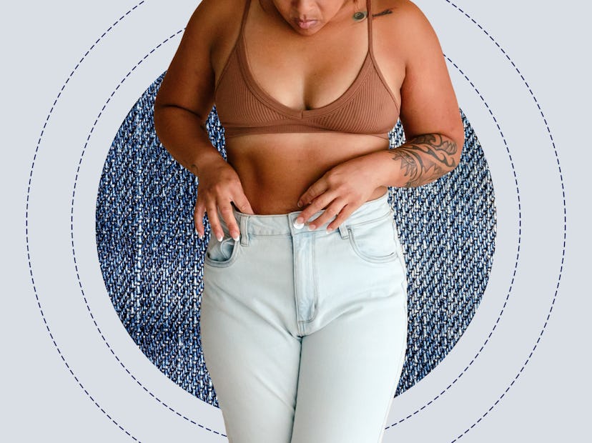 A woman wearing a bra and jeans.