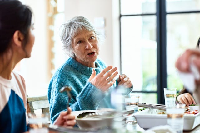 An older woman speaks at a family gathering