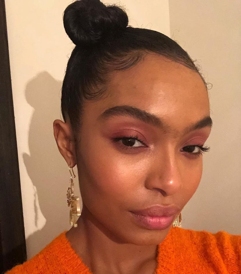 An easy swimming hairstyle for long hair is a topknot like Yara Shahidi's slicked-back bun.
