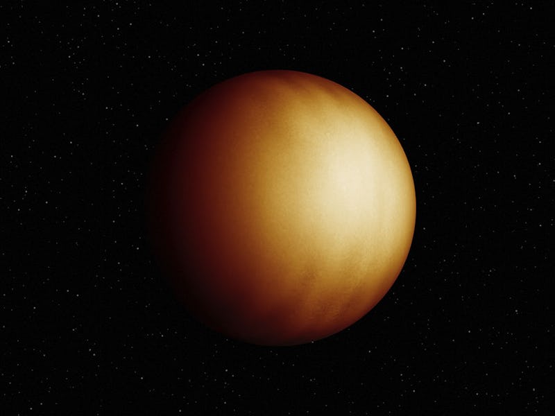 color image of a yellowish planet on a black background