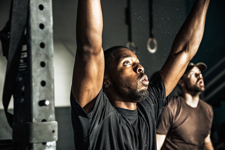 Two men working out in a gym.