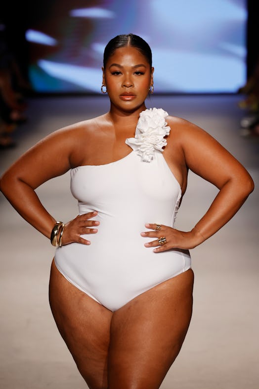 A plus-size model walks the runway for Club L London during Paraiso Miami Swim Week 2023 in a white …