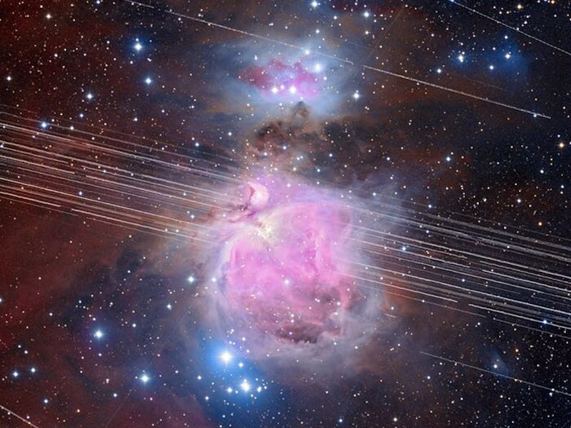 A long-exposure image of the Orion Nebula with a total exposure time of 208 minutes showing satellit...