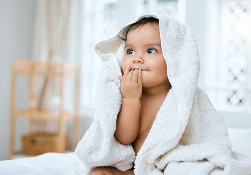 Cute baby in a towel with his fingers in his mouth. Marcus is a good name like Theodore that's far l...