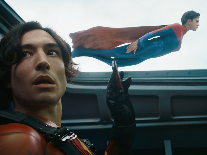 Barry Allen (Ezra Miller) holds up a smartphone in The Flash