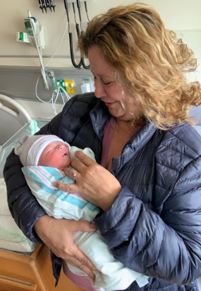 Photo of grandmother meeting grandbaby for the first time