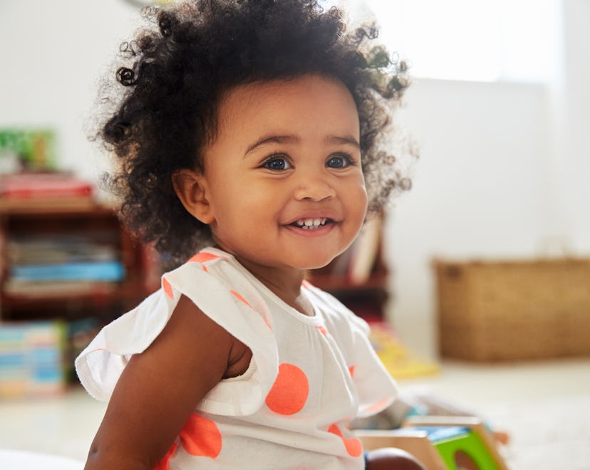 A toddler girl smiling. 
