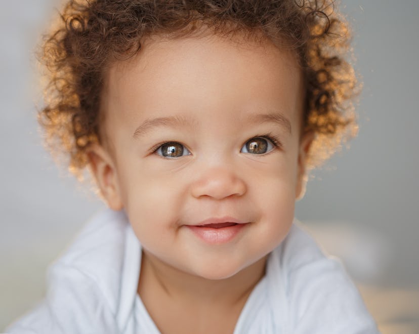 A cute little boy smiling with light behind him. The name Theodore has become increasingly popular i...