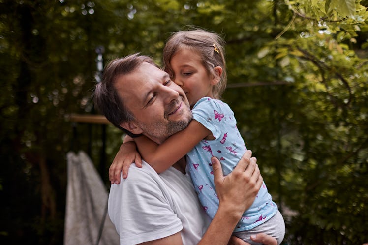 Middle aged man hugging young daughter