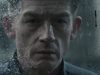 Winston Smith (John Hurt) looks through a rain-soaked window in 1984